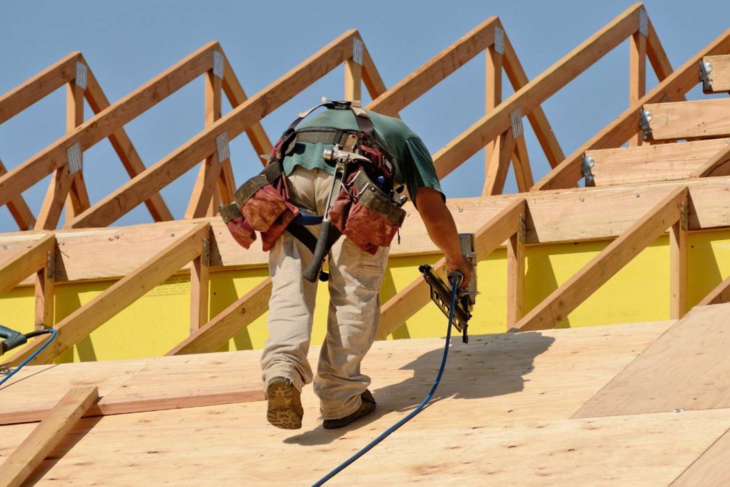 construction worker installing new roof