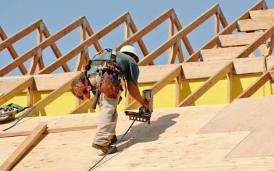 construction worker installing new roof